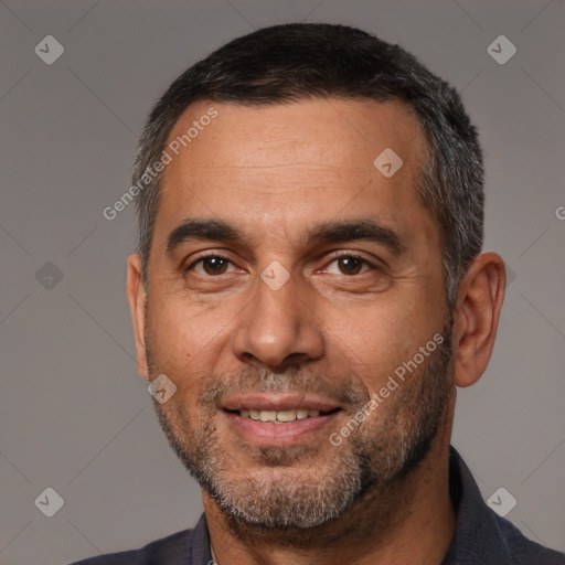 Joyful white adult male with short  black hair and brown eyes