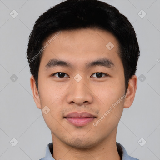 Joyful asian young-adult male with short  black hair and brown eyes