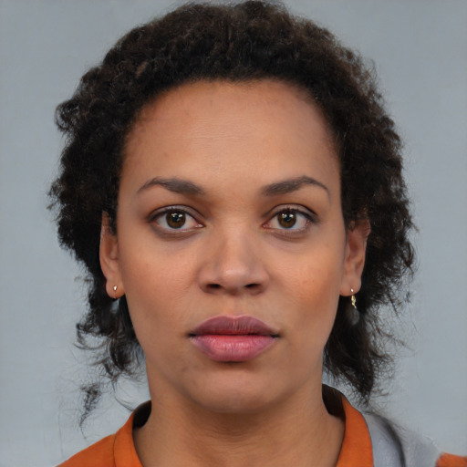 Neutral black young-adult female with medium  brown hair and brown eyes