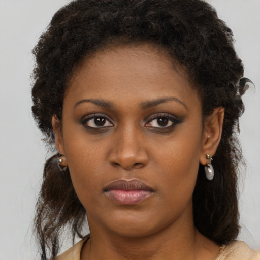 Neutral black young-adult female with medium  brown hair and brown eyes