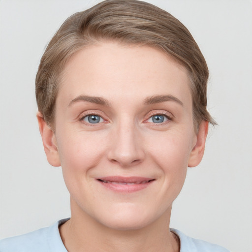 Joyful white young-adult female with short  brown hair and grey eyes