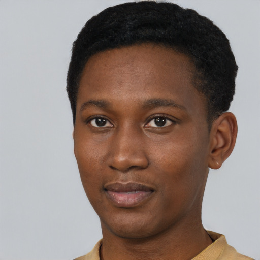 Joyful black young-adult male with short  black hair and brown eyes
