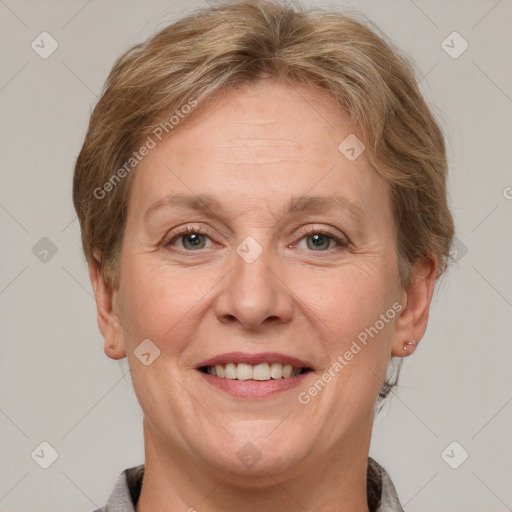 Joyful white adult female with short  brown hair and grey eyes