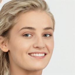 Joyful white young-adult female with long  brown hair and blue eyes