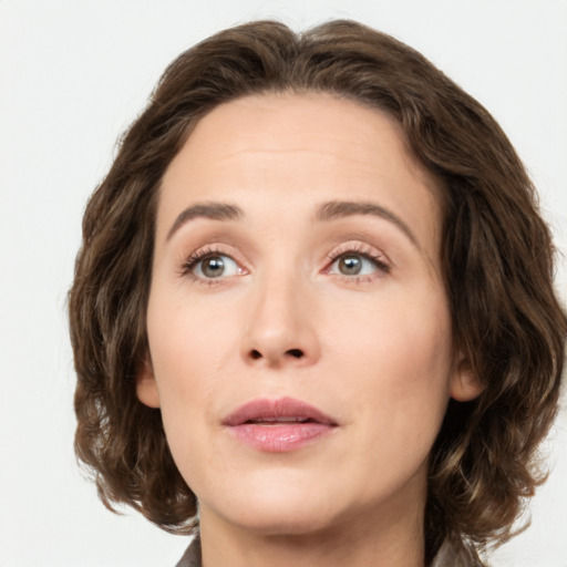 Joyful white young-adult female with medium  brown hair and green eyes