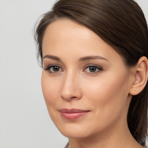 Joyful white young-adult female with medium  brown hair and brown eyes