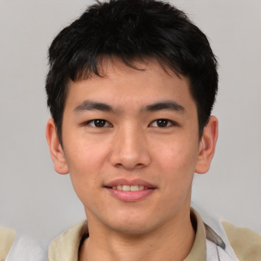 Joyful asian young-adult male with short  brown hair and brown eyes