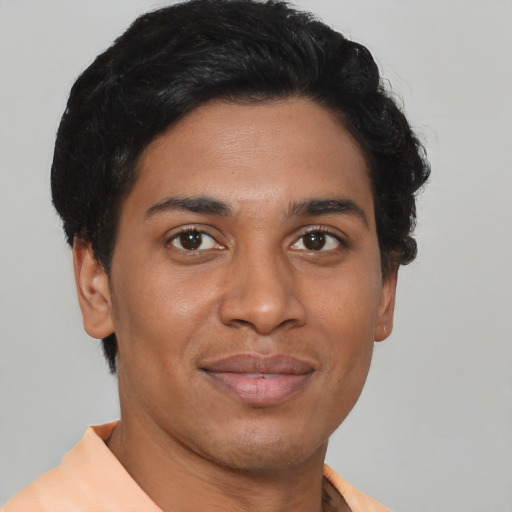 Joyful latino young-adult male with short  brown hair and brown eyes