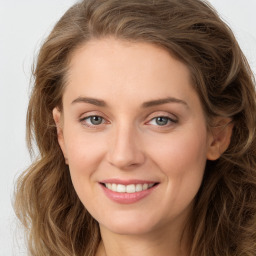 Joyful white young-adult female with long  brown hair and green eyes