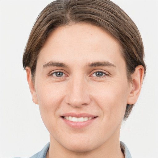 Joyful white young-adult female with short  brown hair and grey eyes