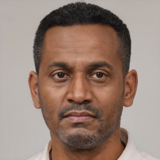 Neutral latino adult male with short  black hair and brown eyes