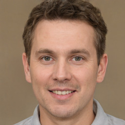 Joyful white adult male with short  brown hair and brown eyes