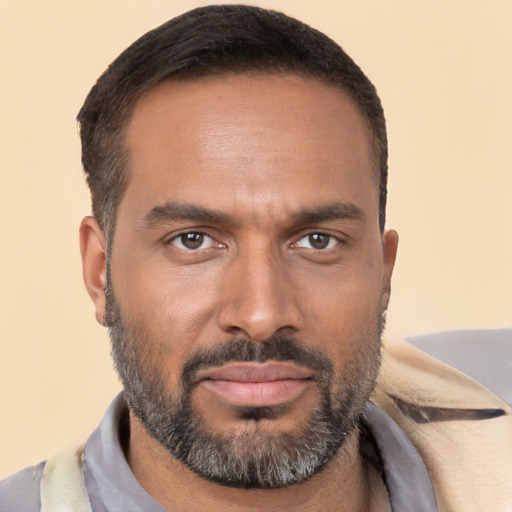 Joyful black adult male with short  brown hair and brown eyes