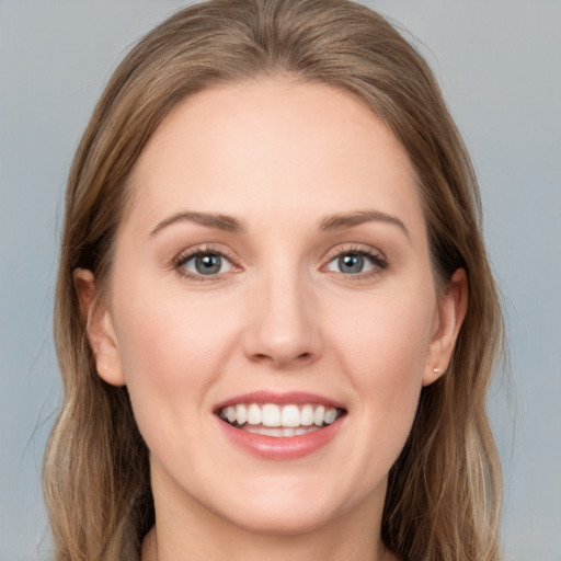 Joyful white young-adult female with long  brown hair and grey eyes