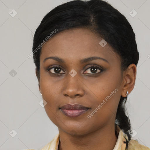 Joyful black young-adult female with medium  brown hair and brown eyes