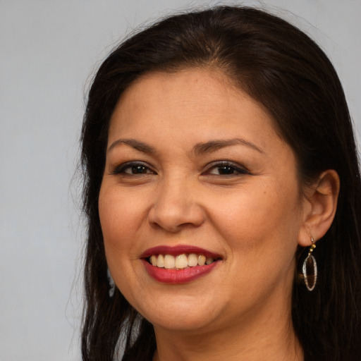 Joyful white adult female with long  brown hair and brown eyes