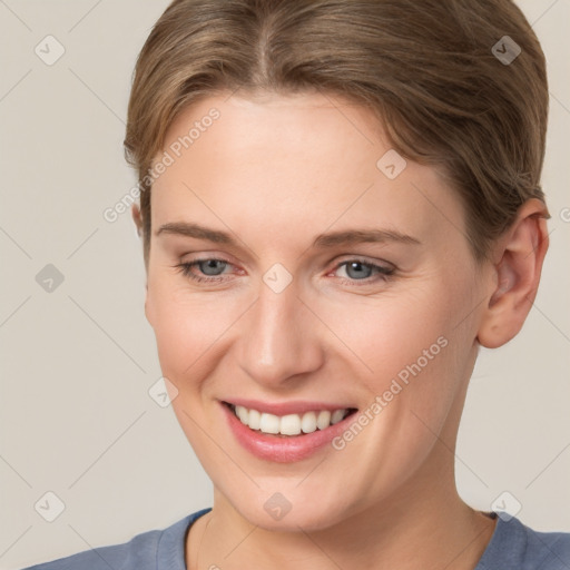 Joyful white young-adult female with short  brown hair and grey eyes