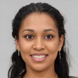 Joyful latino young-adult female with long  brown hair and brown eyes