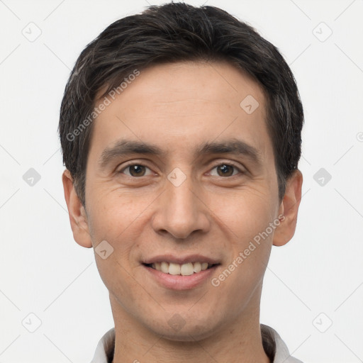 Joyful white young-adult male with short  black hair and brown eyes