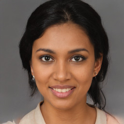 Joyful latino young-adult female with medium  brown hair and brown eyes