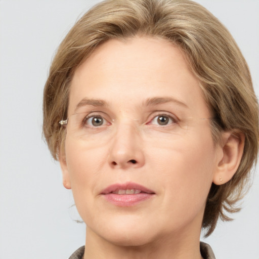 Joyful white adult female with medium  brown hair and grey eyes