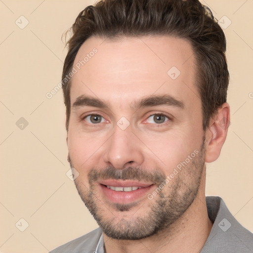 Joyful white young-adult male with short  brown hair and brown eyes