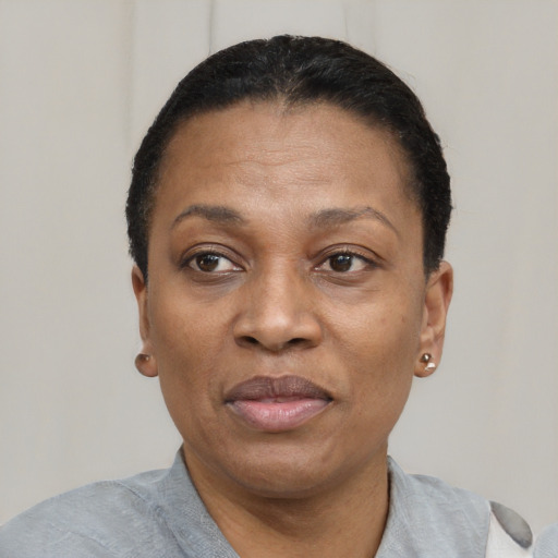 Joyful black adult female with short  black hair and brown eyes