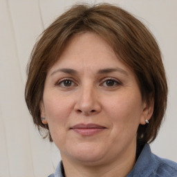 Joyful white adult female with medium  brown hair and brown eyes