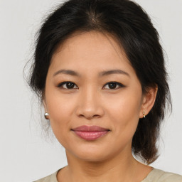 Joyful asian young-adult female with medium  brown hair and brown eyes