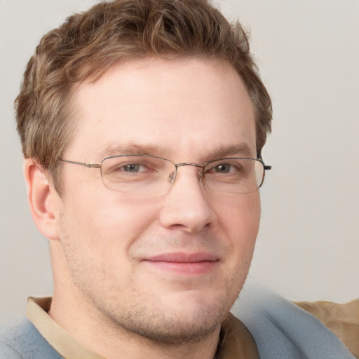 Joyful white adult male with short  brown hair and grey eyes