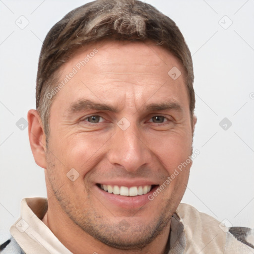 Joyful white adult male with short  brown hair and brown eyes