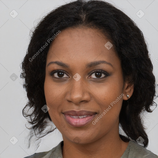 Joyful black young-adult female with long  brown hair and brown eyes