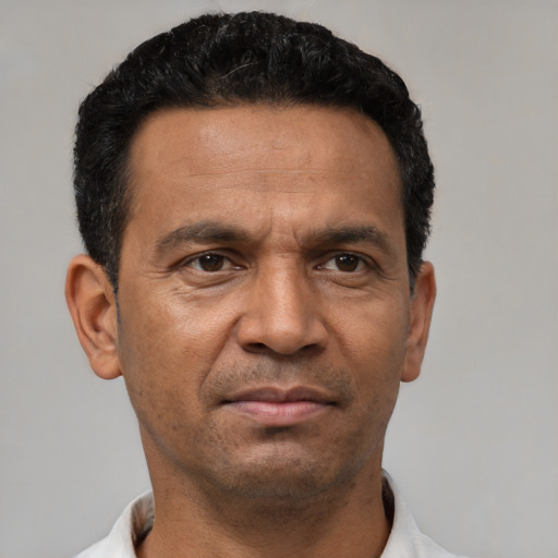 Neutral latino adult male with short  black hair and brown eyes