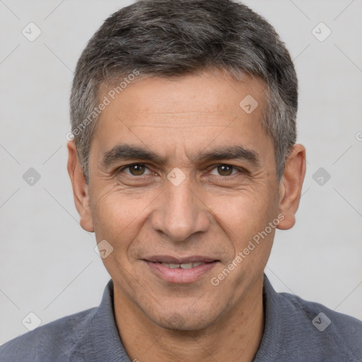 Joyful white adult male with short  black hair and brown eyes