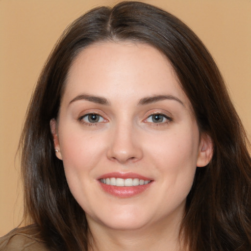 Joyful white young-adult female with long  brown hair and brown eyes