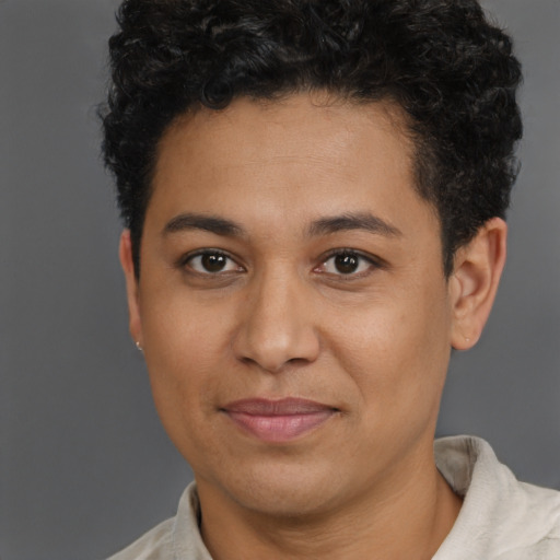 Joyful latino young-adult male with short  brown hair and brown eyes