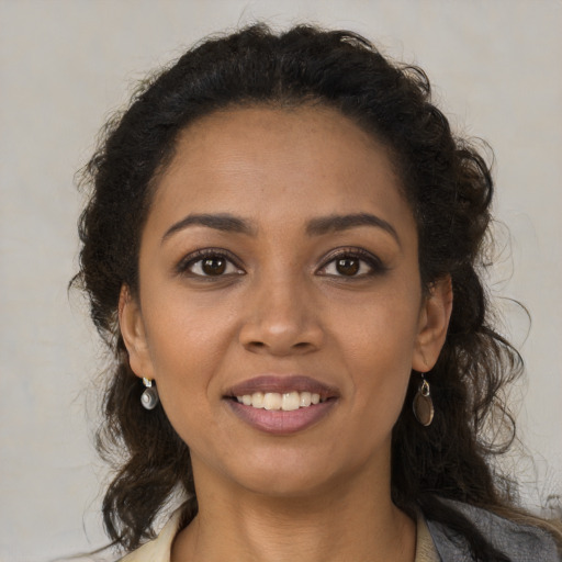 Joyful black young-adult female with medium  brown hair and brown eyes