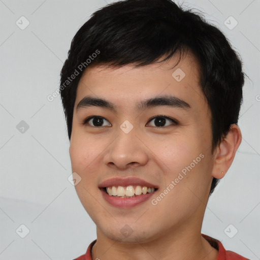 Joyful asian young-adult male with short  black hair and brown eyes