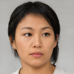 Neutral asian young-adult female with medium  brown hair and brown eyes