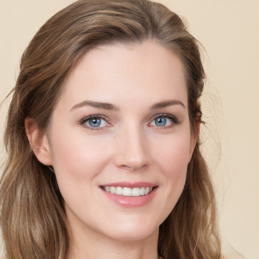 Joyful white young-adult female with long  brown hair and grey eyes