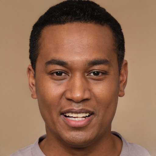 Joyful black young-adult male with short  black hair and brown eyes