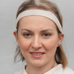 Joyful white young-adult female with medium  brown hair and blue eyes