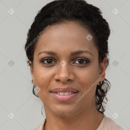 Joyful black young-adult female with long  brown hair and brown eyes