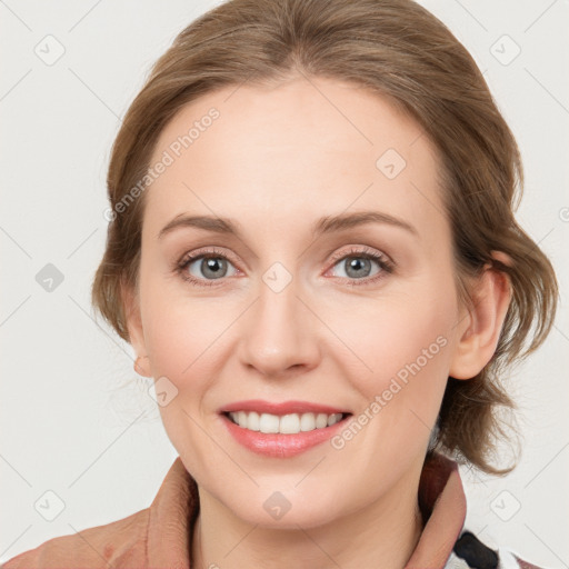 Joyful white young-adult female with medium  brown hair and blue eyes