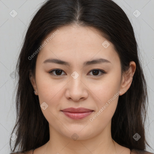 Joyful asian young-adult female with long  brown hair and brown eyes