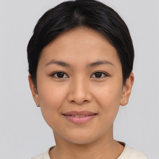 Joyful asian young-adult female with short  brown hair and brown eyes