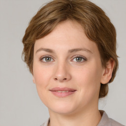 Joyful white young-adult female with medium  brown hair and green eyes