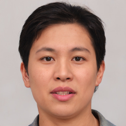 Joyful asian young-adult female with short  brown hair and brown eyes