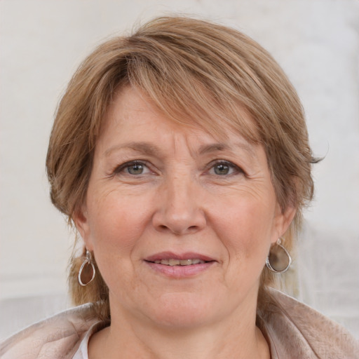 Joyful white adult female with medium  brown hair and grey eyes