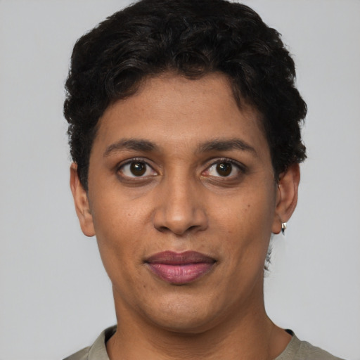 Joyful latino young-adult female with short  black hair and brown eyes